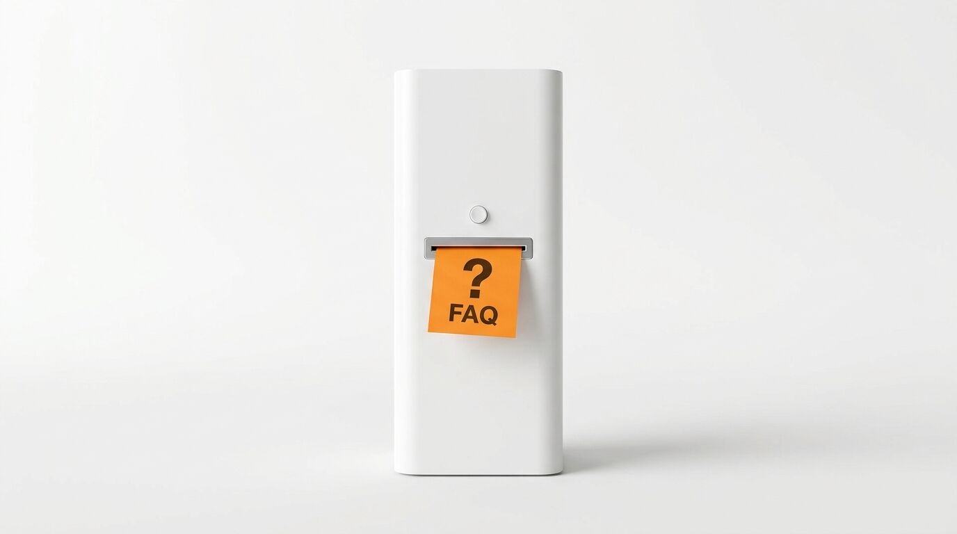 Weißes Gerät mit orangefarbenem Klebezettel, darauf ein Fragezeichen und „FAQ“